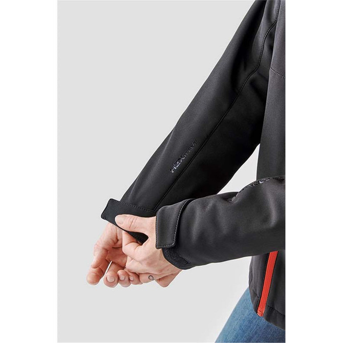 A close-up of a black softshell jacket, highlighting the cuff detail with a logo.