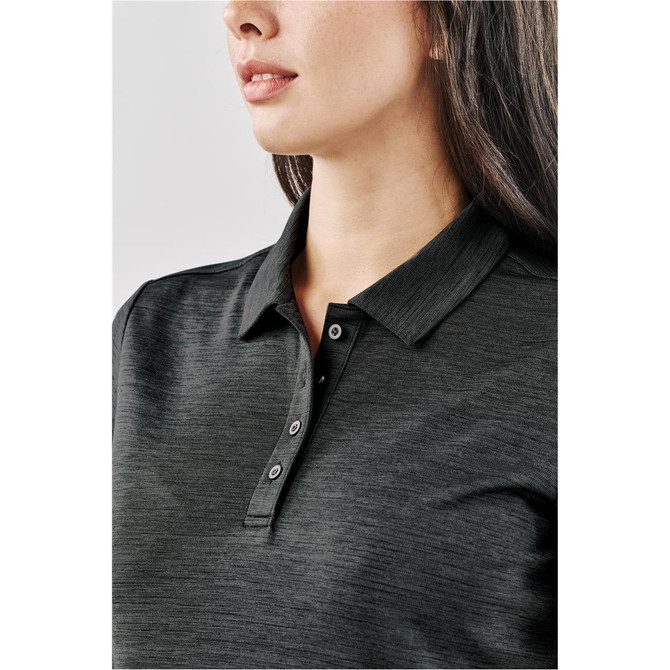 A close-up of a women's polo shirt in dark grey, featuring a collar and buttons. The shirt has subtle texture.