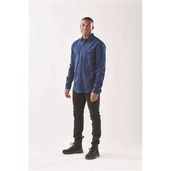 Men's long sleeve twill shirt in navy blue, featuring a button-up design and a chest pocket. The model is wearing black pants and boots.