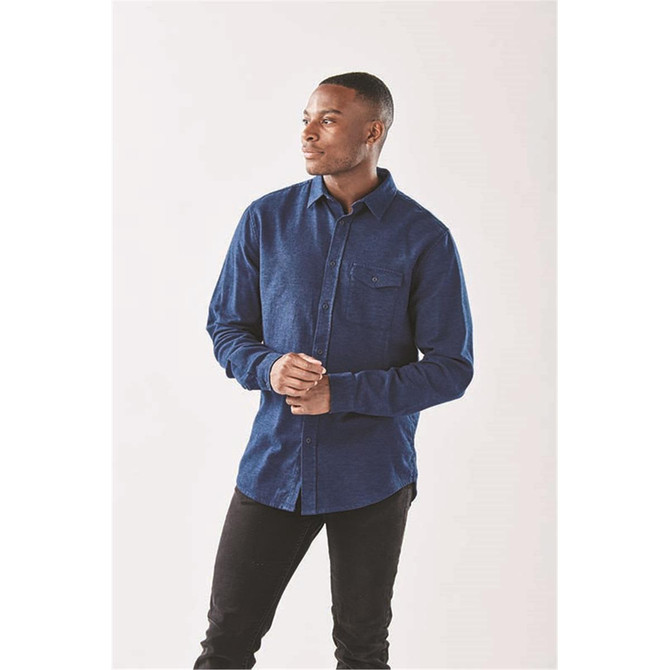 A long sleeve, button-up shirt in navy blue with a pocket and a logo on the chest.