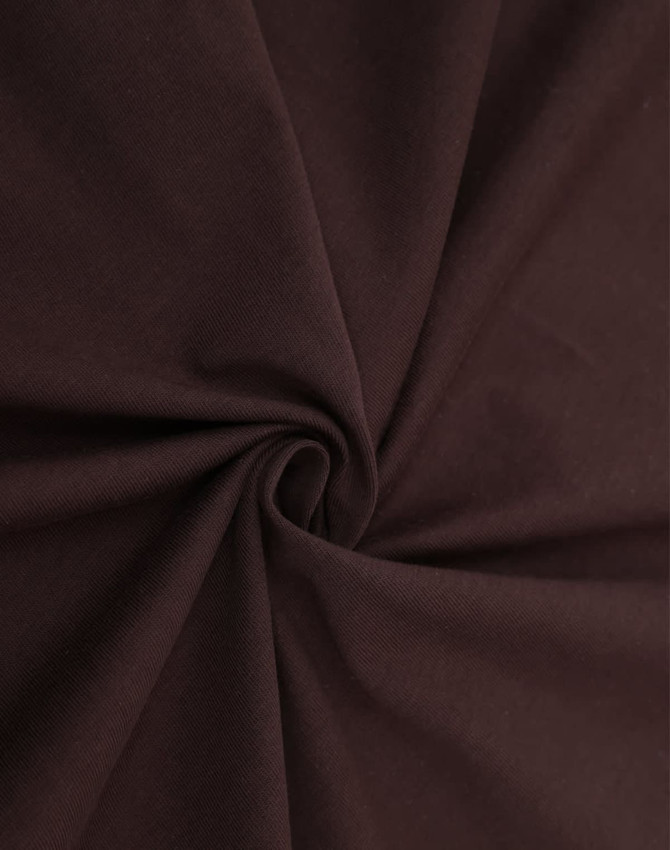 A close-up view of rich brown cotton fabric, showcasing its smooth texture and soft drape.