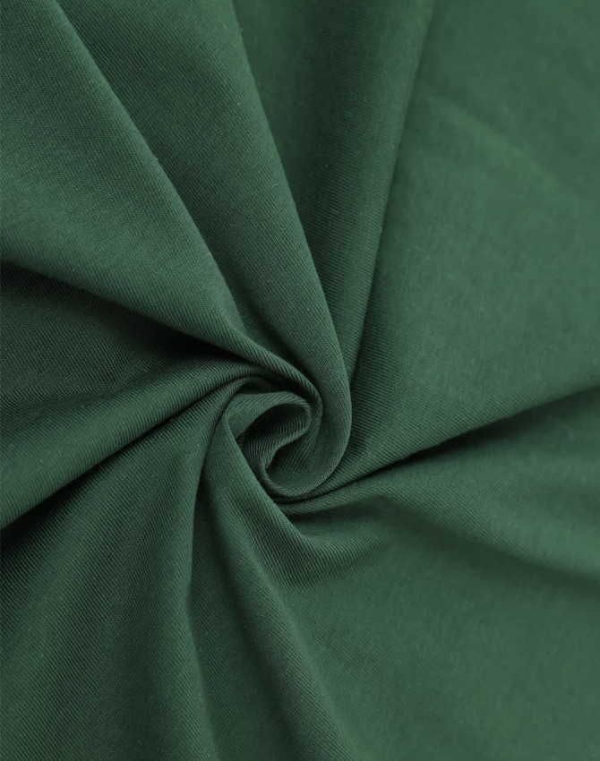 A close-up of dark green cotton fabric featuring a smooth, soft texture. The fabric is gently folded in a spiral.
