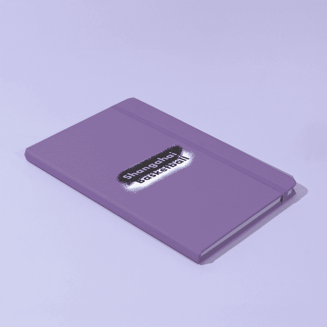 A purple A5 notebook with a logo on the cover, featuring a matching elastic band closure.