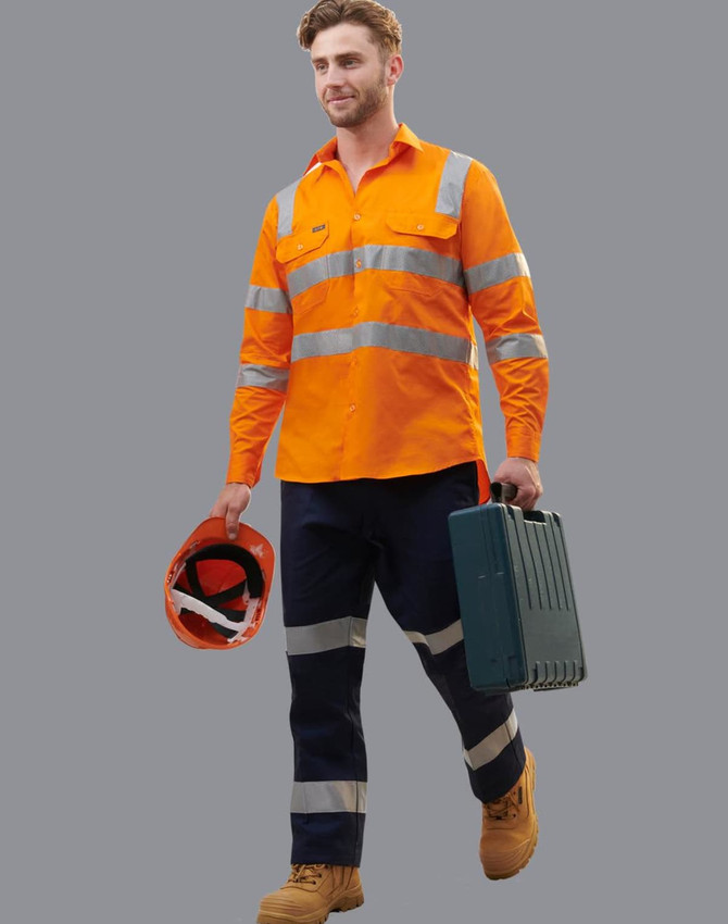 A worker in an orange high-visibility shirt with reflective stripes, wearing navy work pants and holding a helmet and toolbox.