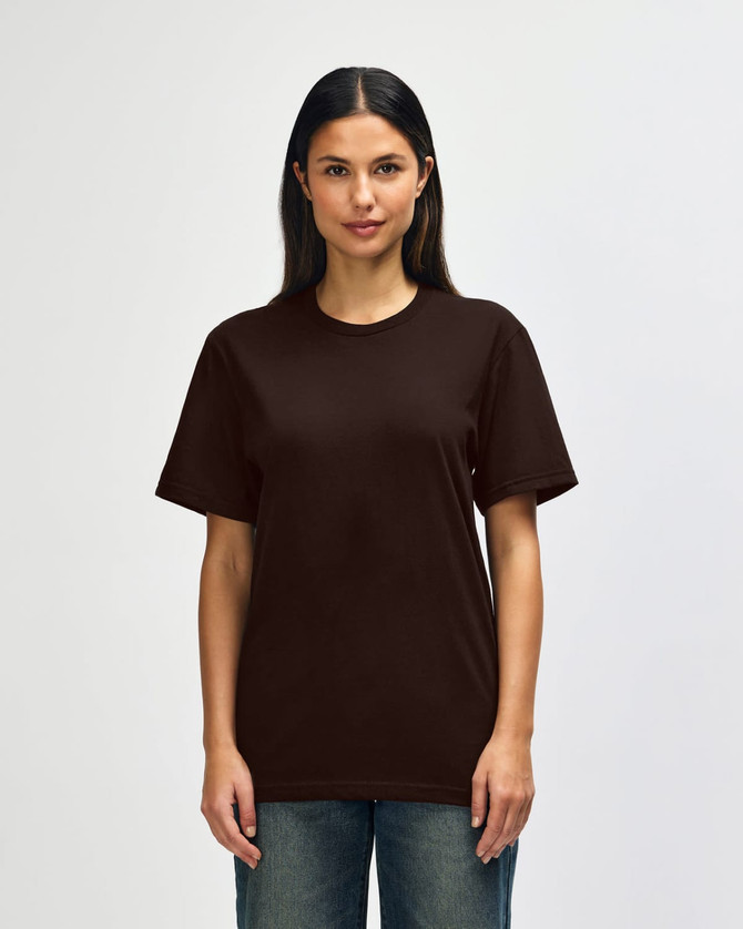 A man is wearing a brown Gildan Softstyle adult t-shirt, featuring a plain design. The shirt has a logo on it.