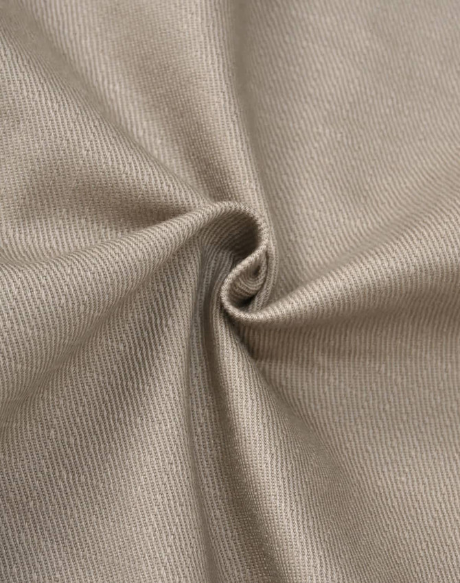 A close-up of beige cotton stretch ripstop fabric, displaying a textured weave and a smooth finish.