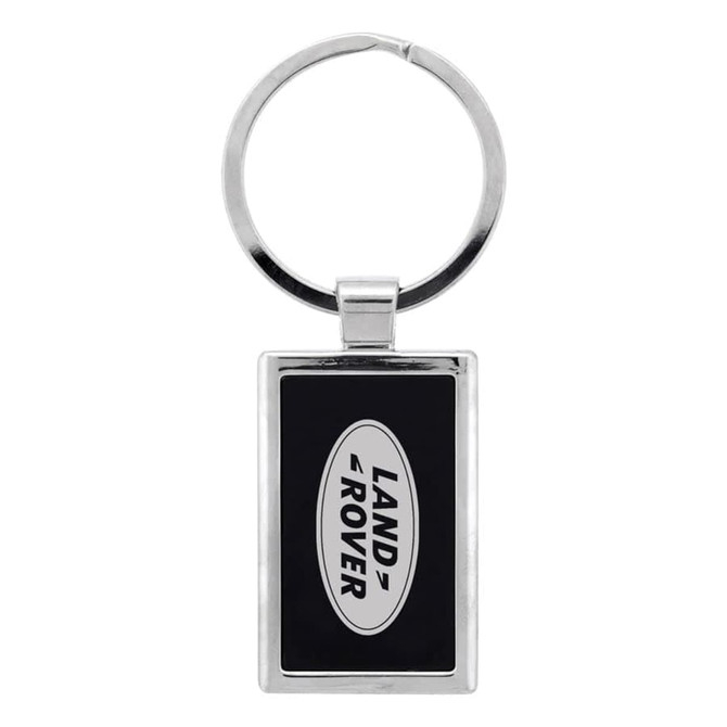A silver keychain featuring a rectangular design with a black background and a logo.