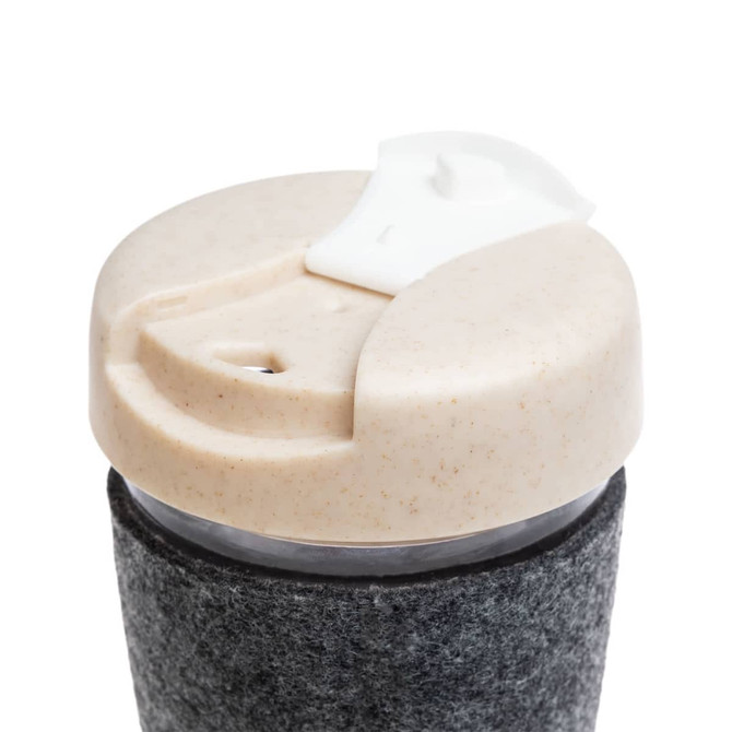 A reusable coffee cup with a gray textured band and a beige lid, featuring a logo on the side.