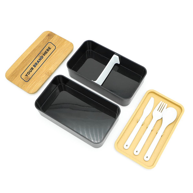 A two-layer black lunch box with a bamboo lid, featuring a white section for utensils. Includes fork and knife.