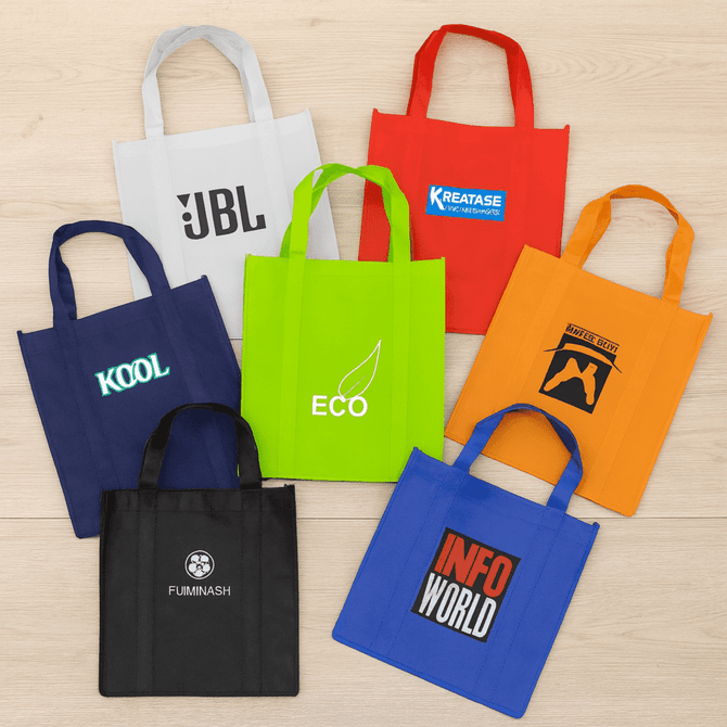 A collection of eight tote bags in various colours, including white, green, orange, blue, and black, with different logos.