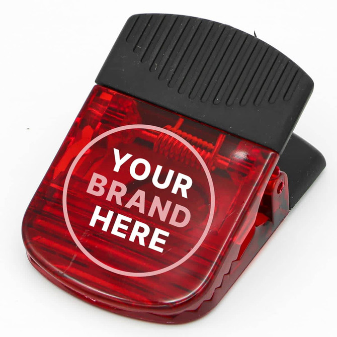 A red magnetic croc clip with a black grip and a branding area on the front.