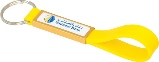 A yellow silicone sling keyring with a dome-indent and a branding logo.