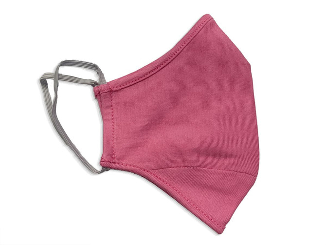A pink face mask made of 100% cotton with earpieces for secure wear. The mask features a simple design.