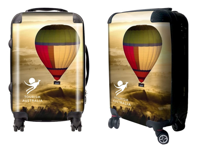 A wheeled suitcase features a colourful hot air balloon design and includes a logo. The suitcase is predominantly yellow and red.