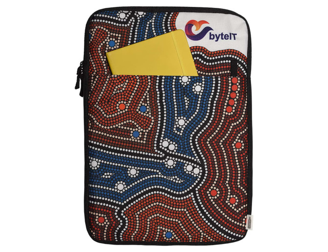A laptop sleeve featuring a vibrant Aboriginal art design in red, blue, and black, with a yellow notebook in the front pocket.