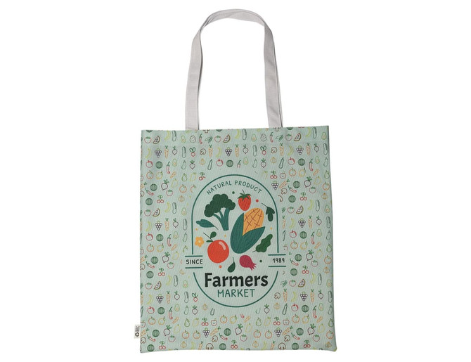 A green tote bag featuring a farm-themed design and a logo, with white straps and illustrations of fruits and vegetables.