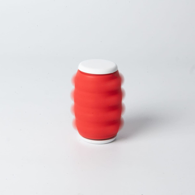 A red drink bottle with a white lid and a textured design, displaying motion blur effects.