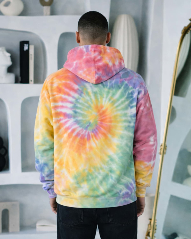 A hooded sweatshirt featuring a vibrant tie-dye pattern in pastel colours, including yellow, pink, blue, and green.
