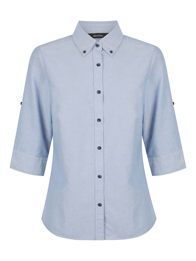 A light blue ladies' button-up shirt with 3/4 sleeves and a collar, featuring a logo on the label.