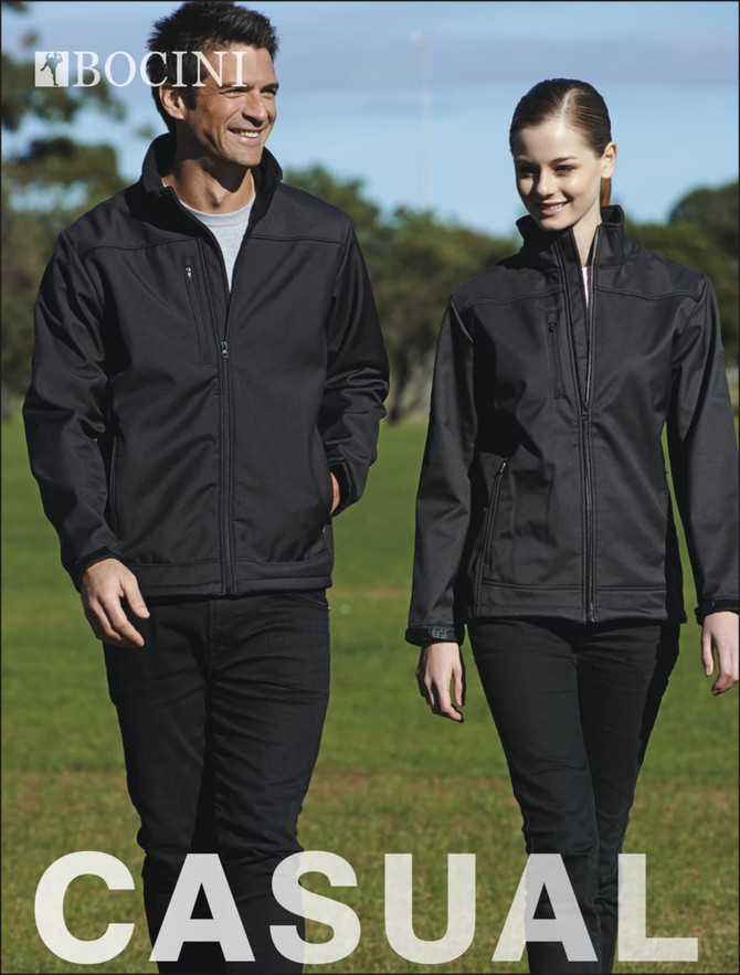 A soft shell jacket in black, worn by a man and a woman, walking on grass in a casual outdoor setting.