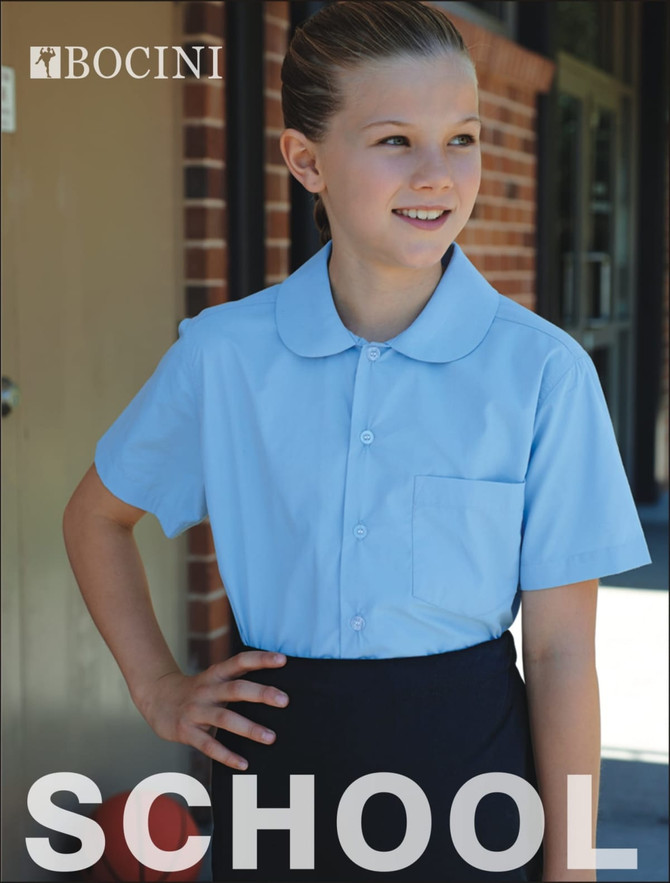 A short-sleeve school shirt in light blue with a Peter Pan collar and a pocket, featuring a logo on the upper left.