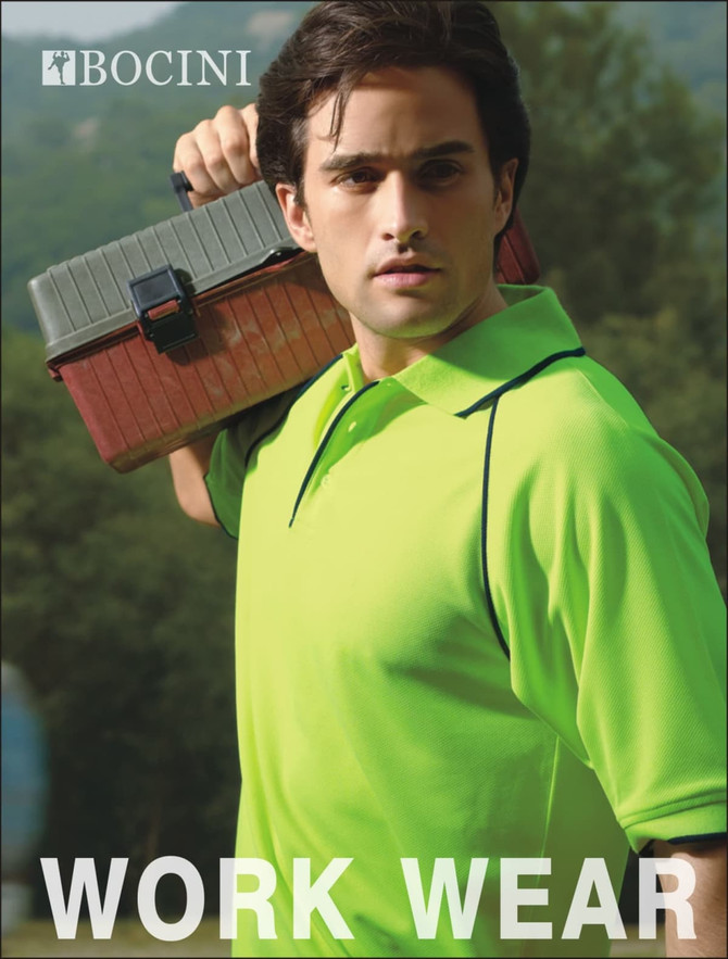 A man in a bright green hi-vis polo shirt holds a toolbox, with a natural background. The shirt features a logo.