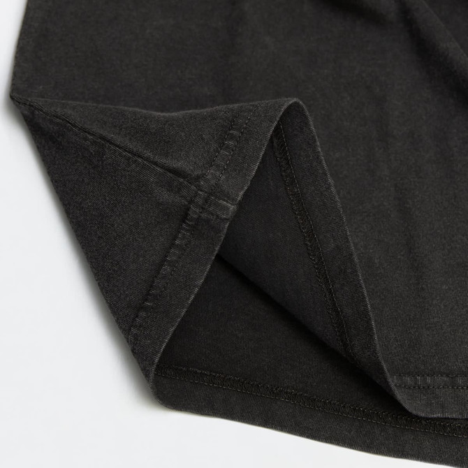 A faded black unisex T-shirt featuring a simple design and a subtle logo on the fabric.