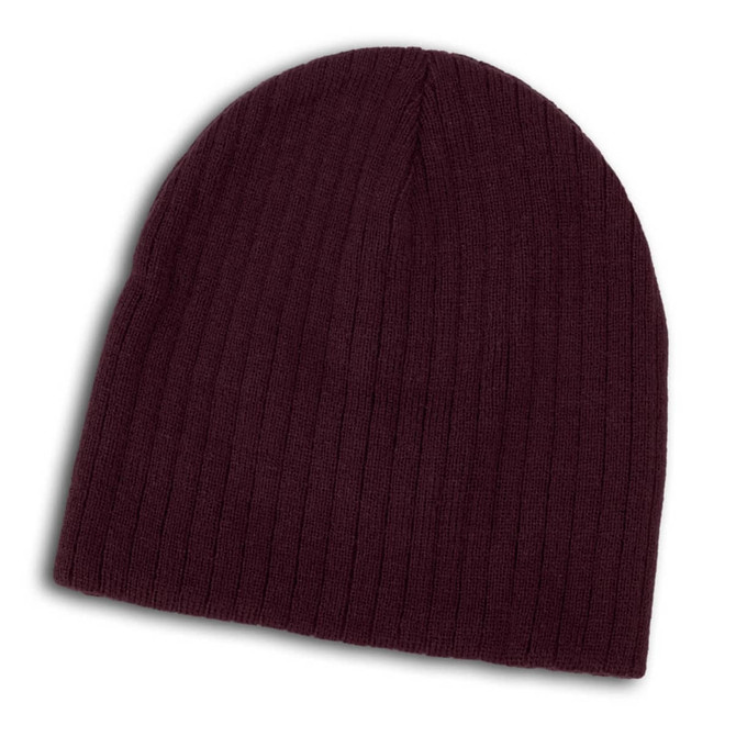 A Nebraska Cable Knit Beanie in a rich burgundy color, featuring a ribbed texture.