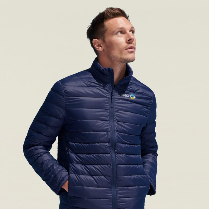 A navy puffer jacket for men featuring a high collar and a logo on the chest, modelled by a man looking upwards.