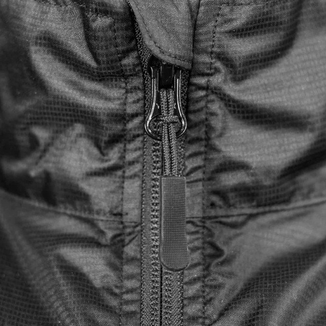 A black windbreaker featuring a central zip closure, showcasing a soft shell texture and a sleek design.
