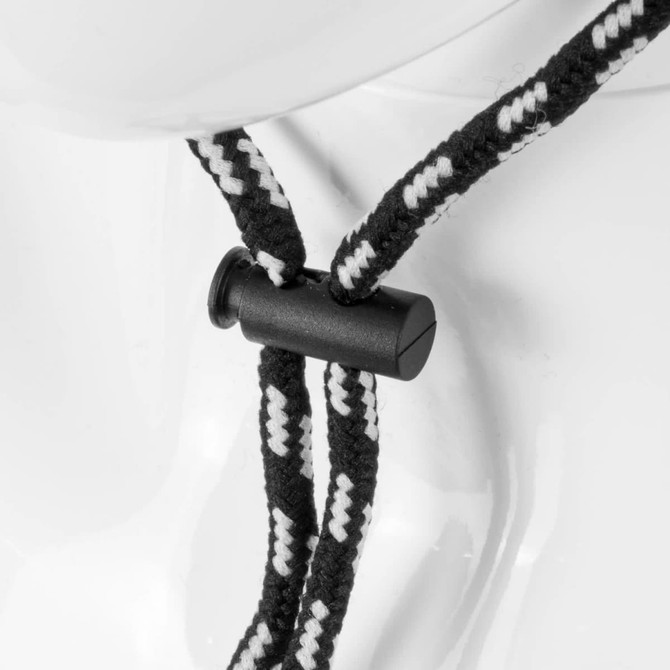 A close-up of a black and white braided chin strap with a plastic toggle, designed for securing hats.