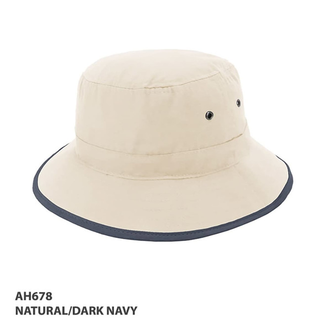 A beige microfibre bucket hat with a dark navy brim, featuring ventilation eyelets and a logo.