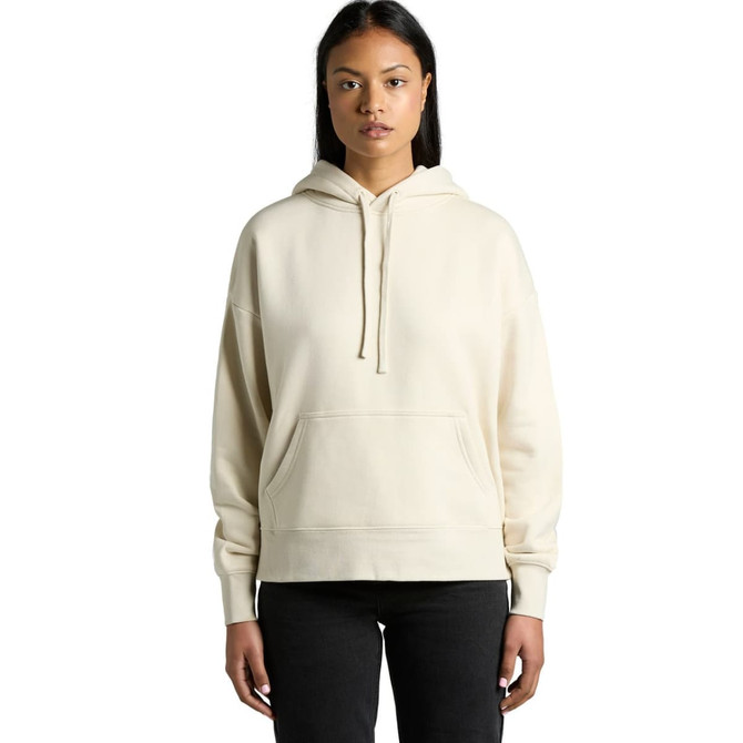 A light cream hoodie with a front pocket and a hood, displayed on a model. The item has a branding logo.