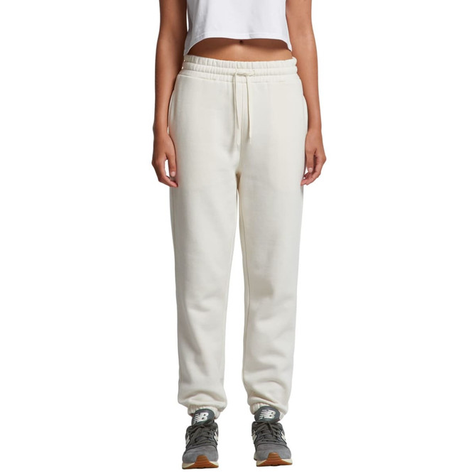 Cream track pants with an elastic waistband displayed on a model, featuring a logo.