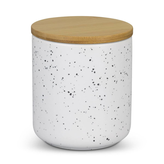 A white speckled candle jar with a bamboo lid, designed for home decor.