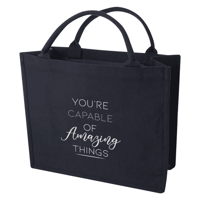 A navy blue tote bag with two handles and a logo, featuring the phrase "You're capable of amazing things."