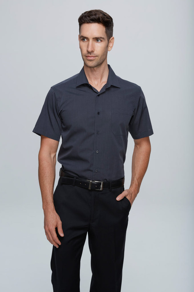 A short sleeve, button-up men's shirt in a deep blue colour with a chest pocket and a branded tag.