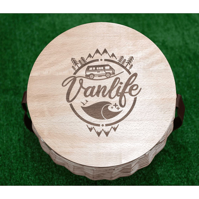 A circular wooden cooler basket lid featuring a "Vanlife" design with a camper van and wave illustration.
