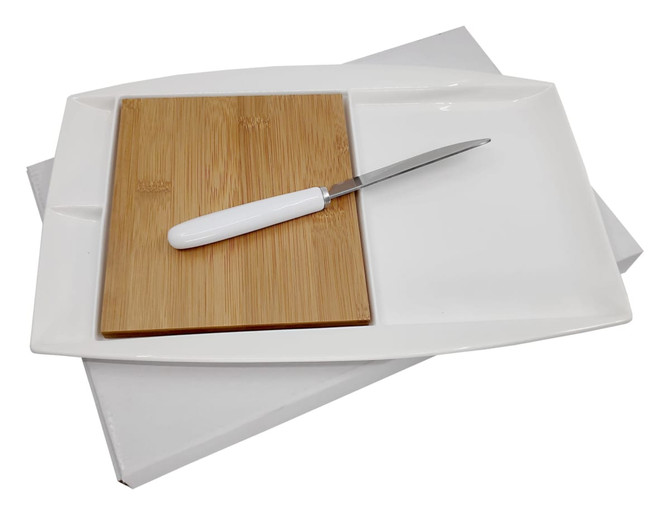 A white Jumbo Party Plate with a bamboo cutting board and a metal knife, set against a plain background.