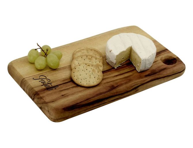 A wooden cheese board with a logo, featuring brie cheese, crackers, and green grapes.