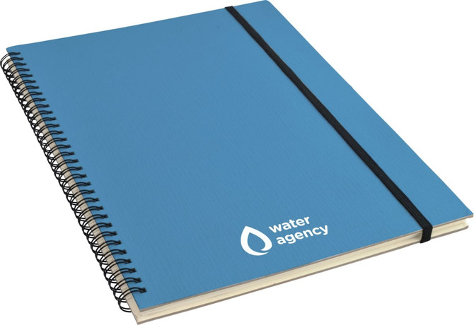 A blue A4 notebook with a spiral binding and an elastic band, featuring a logo on the cover.