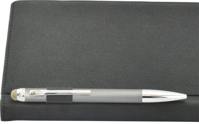 A black A5 notebook with a silver pen resting on top, featuring a smooth texture and a logo on the cover.