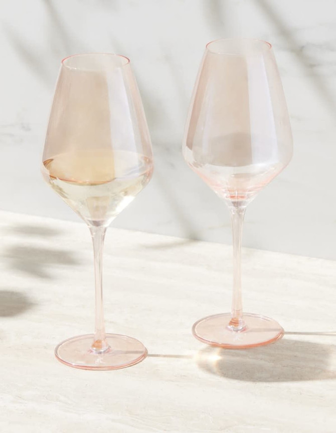 A set of two elegant wine glasses in a soft pink hue, presented in a stylish gift box.