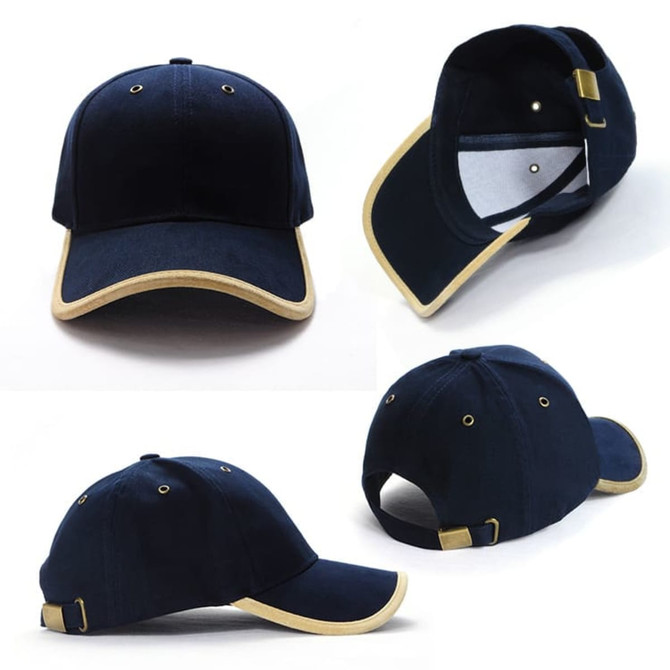 A navy blue cap with suede trim, featuring a logo and an adjustable strap at the back.