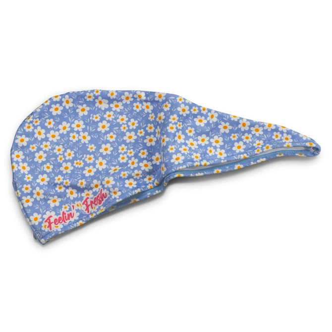 A blue hair towel with a floral pattern, featuring daisies in white and yellow, and a logo.