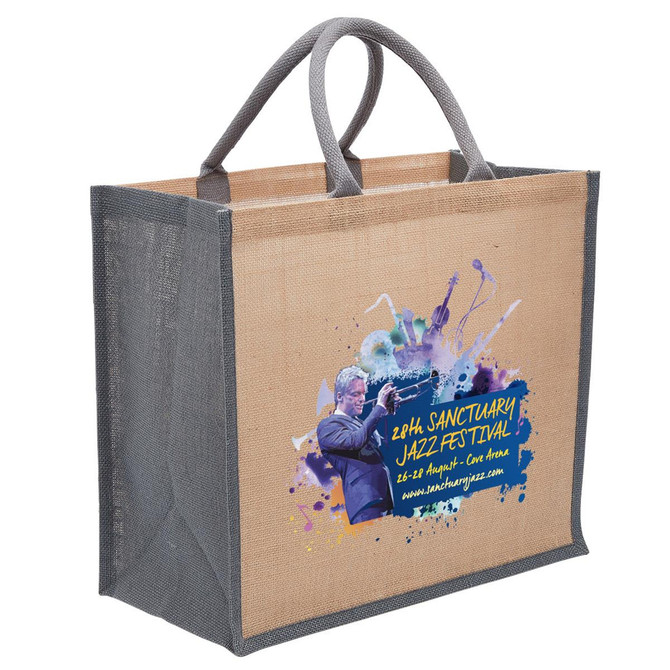 A jute tote bag in natural and grey, featuring a logo and vibrant artistic design on the side.