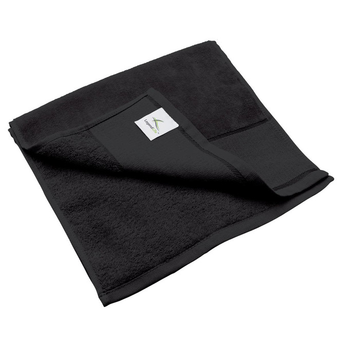 A black fitness towel, featuring a folded corner and a small branded label on its edge.