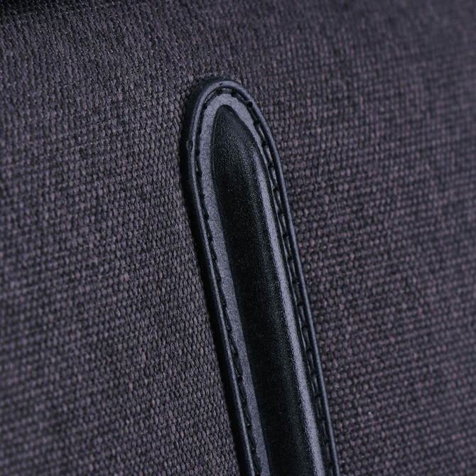 A close-up of a dark grey fabric with a black leather accent, part of the Swissdigital Arosa Duffle Bag.