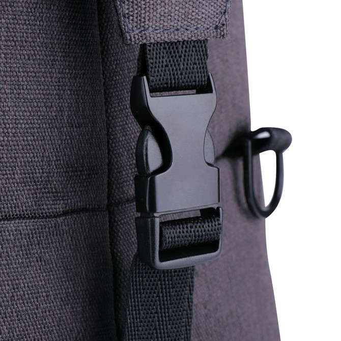 A close-up of a dark grey duffle bag featuring a black plastic buckle and strap.
