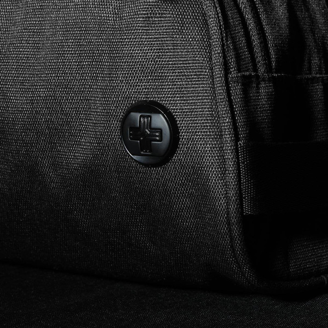 A black wash bag featuring a textured fabric and a logo button. Ideal for toiletries and accessories.